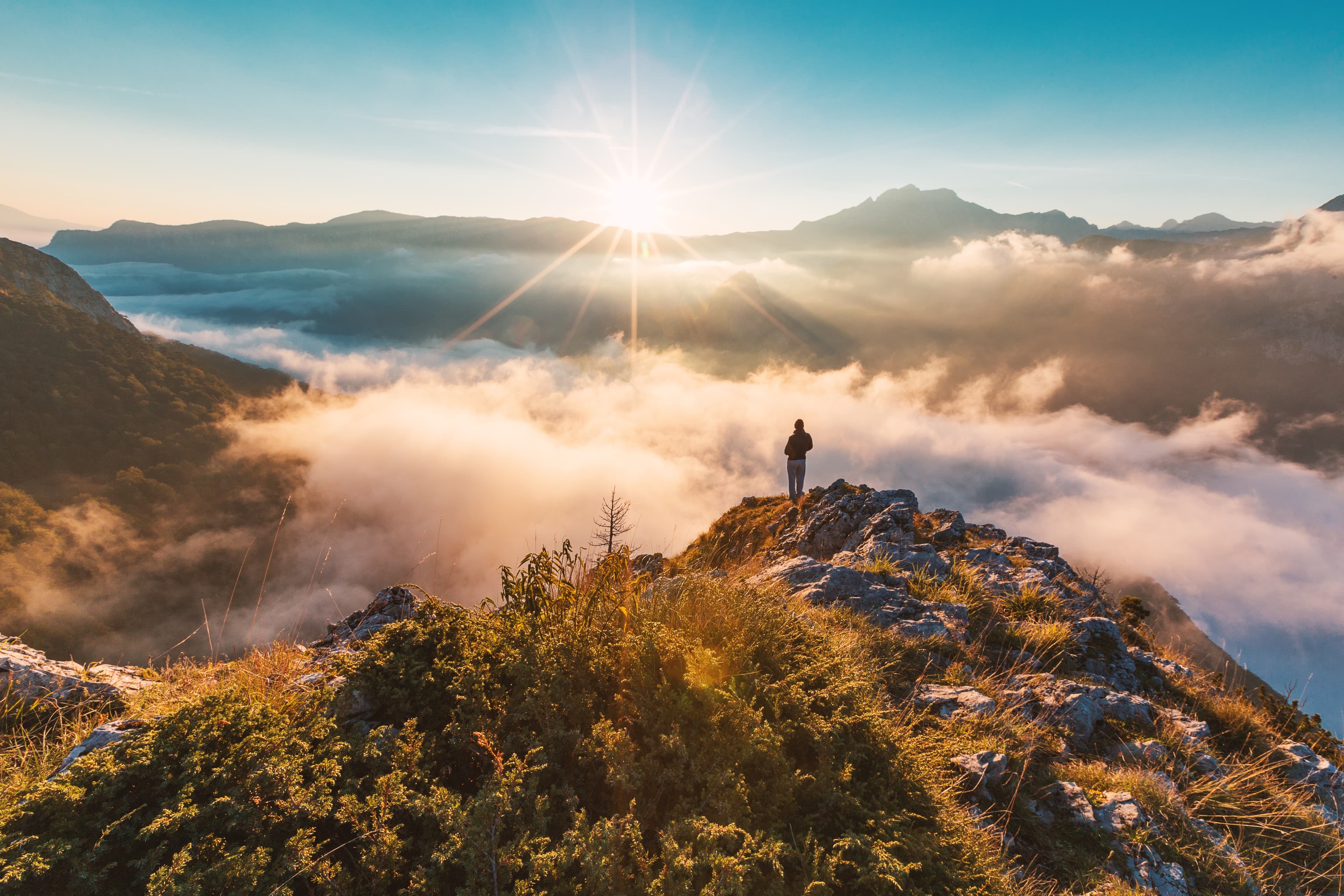 Lone hiker on a mountain top